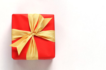 Red gift box isolated on white with close-up.