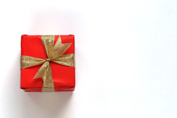 Red gift box isolated on white with close-up.