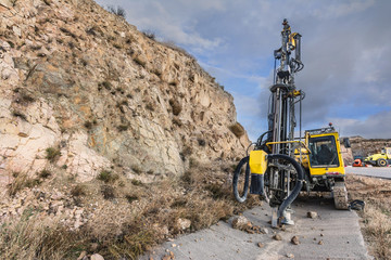 Drilling machine breaking the concrete to repair a road