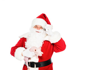 Fototapeta na wymiar santa claus holding little pig in hand and looking up isolated on white
