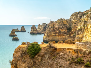 Fototapeta na wymiar Rocks, Cliffs And Ocean Landscape At Lagos Bay Coast In Algarve, Portugal