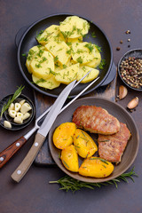 Cooked pork with peach in plate and potato
