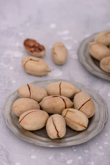 Bowl with pecan nuts on gray stone table