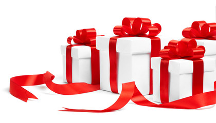Christmas gift boxes with red ribbons on white background
