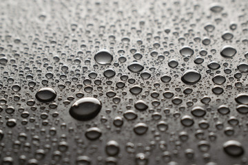 Drops of water on a dark glass texture background