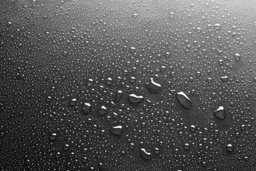 Drops of water on a dark glass texture background
