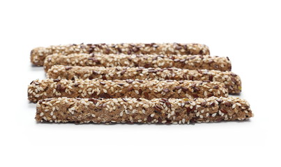 Pretzel bread sticks with sesame and linen, flax seeds isolated on white background