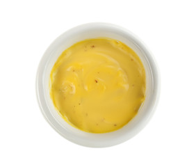 Tasty yellow sauce in bowl on white background