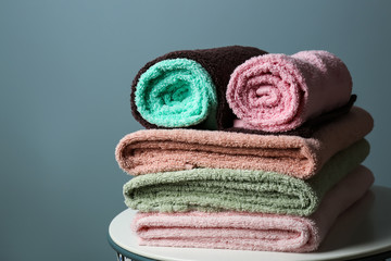 Obraz na płótnie Canvas Stack of clean soft towels on grey background