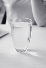 Glass of fresh water on white table