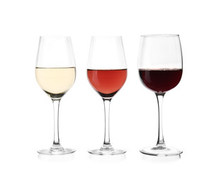 Glasses with different kinds of wine on white background