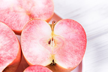 Apples with pink flesh on a light background