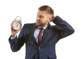 Emotional businessman with alarm clock on white background