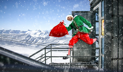 Christmas time and elf with winter landscape of mountains. 