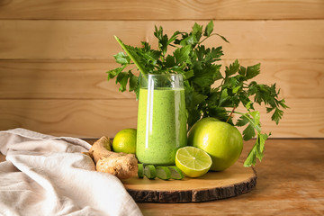 Glass of healthy aloe cocktail on wooden table