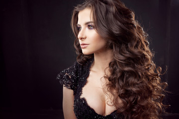 Portrait of a young attractive woman with gorgeous curly hair. Attractive brunette.