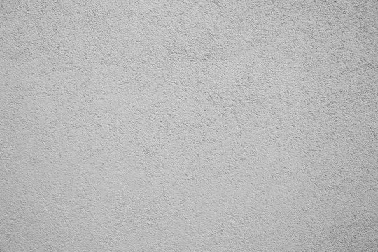White and gray wall close-up texture photo. Stucco background with fine grain