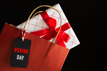 Boxing day Sale shopping bag and gifts boxes with message tag. Online shopping concept.