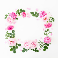 Floral frame of pastel pink roses, peonies and green leaves on white background. Flat lay, top view. Spring time composition