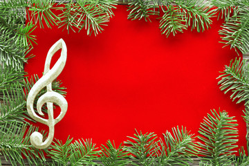 Christmas tree branch on red velvet with music clef 