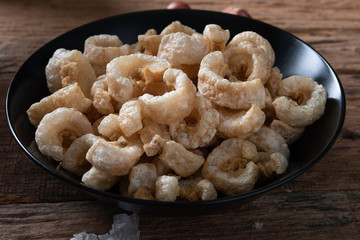 Pork rinds also known as chicharon or chicharrones , kab moo