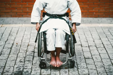 Tuinposter Woman who training karate with wheelchair © karrastock