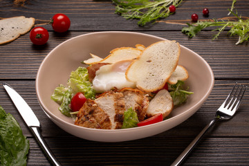 Ceasar salad with a poached egg on top.