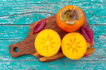 Ripe fruit khaki on a wooden board.
