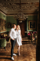 Young couple stand in they apatrament near the big window