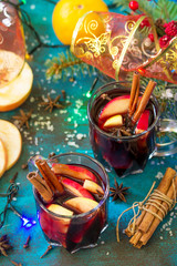 Christmas Mulled Wine or Sangria with Spices. Two glasses of hot mulled wine with Apple and spices on blue slate table. Copy space.