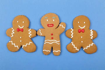 Christmas cookies, gingerbread In the form of a man on blue background. Christmas background