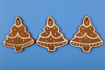 Christmas cookies, gingerbread In the form of a Christmas tree on blue background. Christmas background