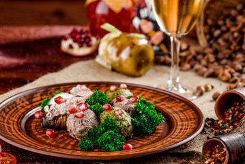 Georgian dish - phali of spinach and meat on a brown plate on a wooden background. close-up