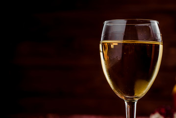 glass of white wine on a dark background