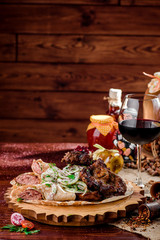 Georgian cuisine. grilled meat with onions, pita bread with sausages and a glass of rad wine on a wooden board on a burlap. top view. flat lay. close-up.