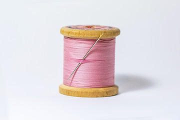 spool of thread and needle pink studio