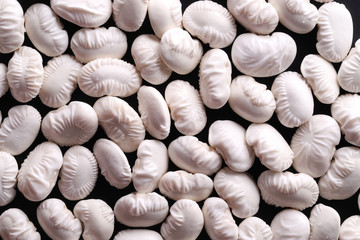 Soaked white kidney beans on black background