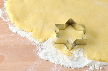 baking christmas star shape cookies. fresh dough.