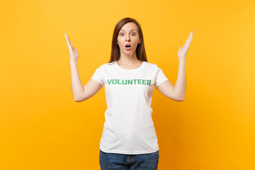 Portrait of sad upset shocked young woman in white t-shirt with written inscription green title...