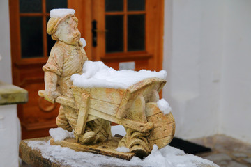 funny boy figurine with a wheelbarrow.