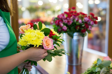 Workshop florist, making bouquets and flower arrangements. Woman collecting a bouquet of flowers