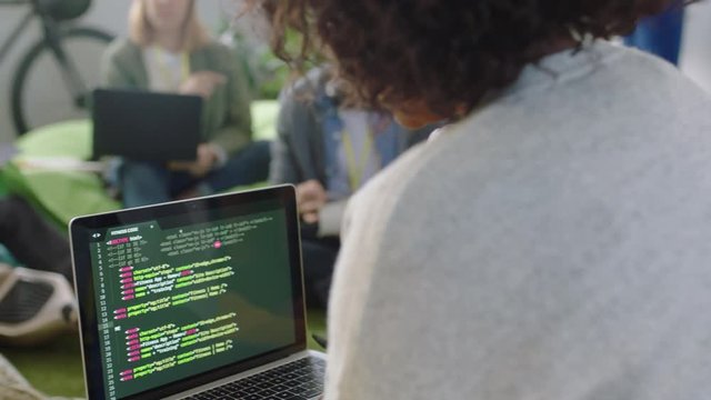 young business people meeting programmers brainstorming software developers discussing code sharing ideas for project using laptop computer technology enjoying intelligent communication in office