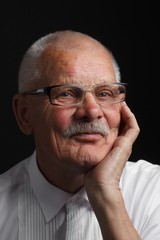 Contemplative old man in glasses
