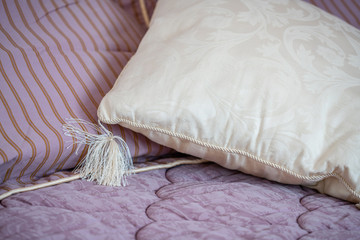Fototapeta na wymiar Decorative white pillow on a bed