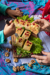 Pkhali rolls in cabbage leaves with vegetables, pomegranate grains and walnut paste - traditional Georgian cold appetizer snack food.
