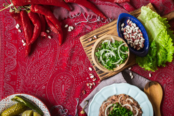 Lobio - traditional Georgian dish with red beans, cilantro, ajika spice served with pickles vegetables. Vegan vegetarian healthy food