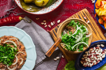 Obraz na płótnie Canvas Lobio - traditional Georgian dish with red beans, cilantro, ajika spice served with pickles vegetables. Vegan vegetarian healthy food