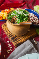 Lobio - traditional Georgian dish with red beans, cilantro, ajika spice served with pickles vegetables. Vegan vegetarian healthy food