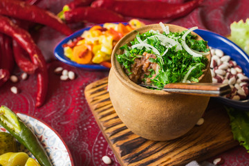 Lobio - traditional Georgian dish with red beans, cilantro, ajika spice served with pickles vegetables. Vegan vegetarian healthy food