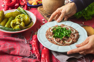 Lobio - traditional Georgian dish with red beans, cilantro, ajika spice served with pickles vegetables. Vegan vegetarian healthy food